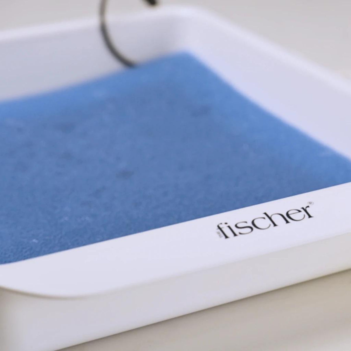 Close up image of the white electrode trays and blue pH-balancing foam for the Fischer iontophoresis device, used to treat hyperhidrosis (excessive sweating)